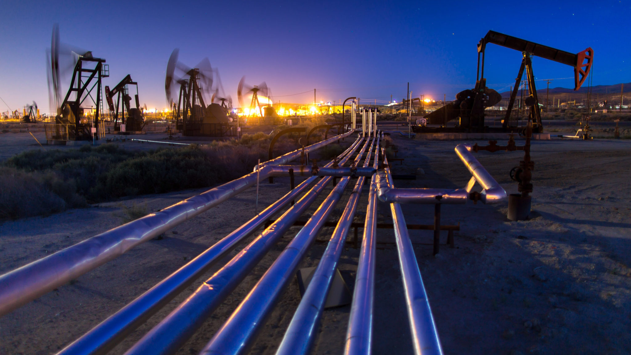 Long Exposure Shoot of Pump Jacks in Oil Field at Night Canadian